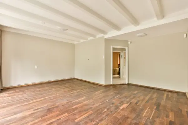 an empty living room with wood floors and white floors