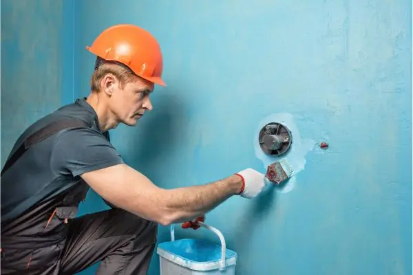 basement contractor applying waterproofing solution 