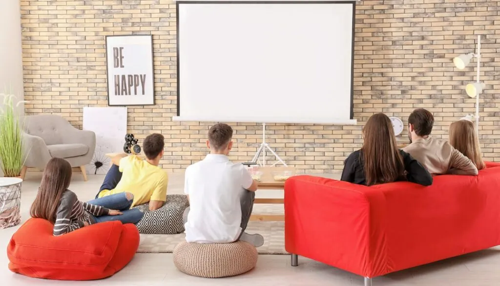 group of friends watching on basement using projector