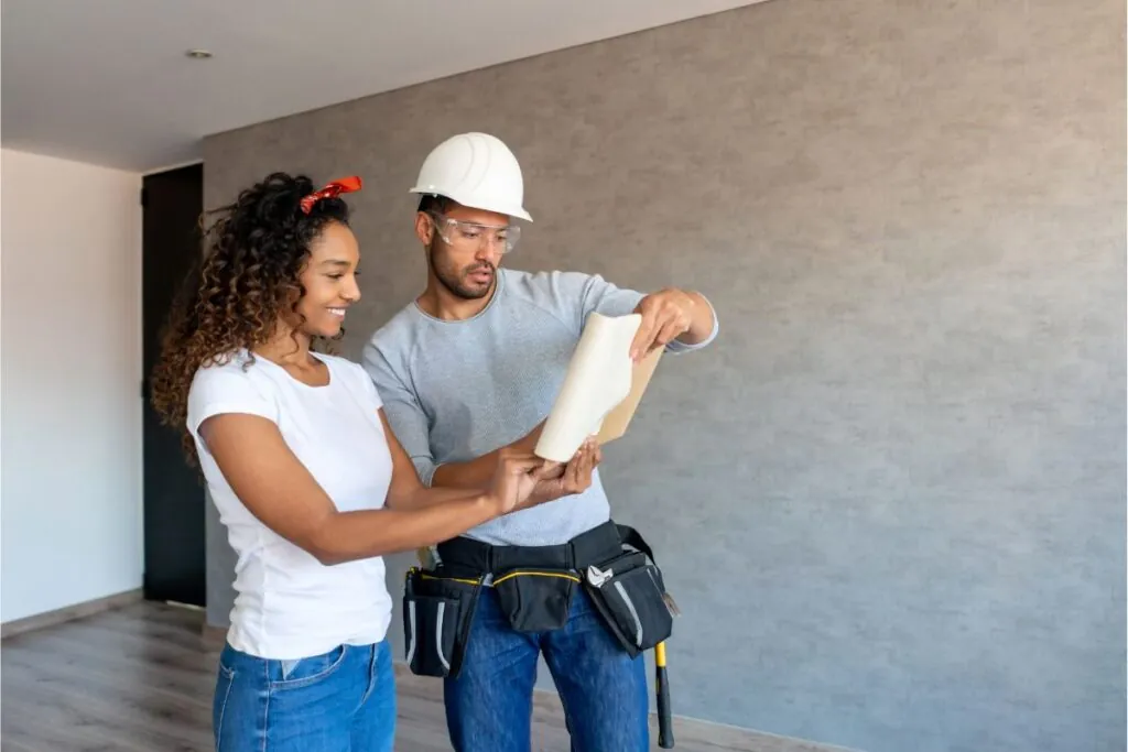 happy woman talking to the contractor remodeling her basement