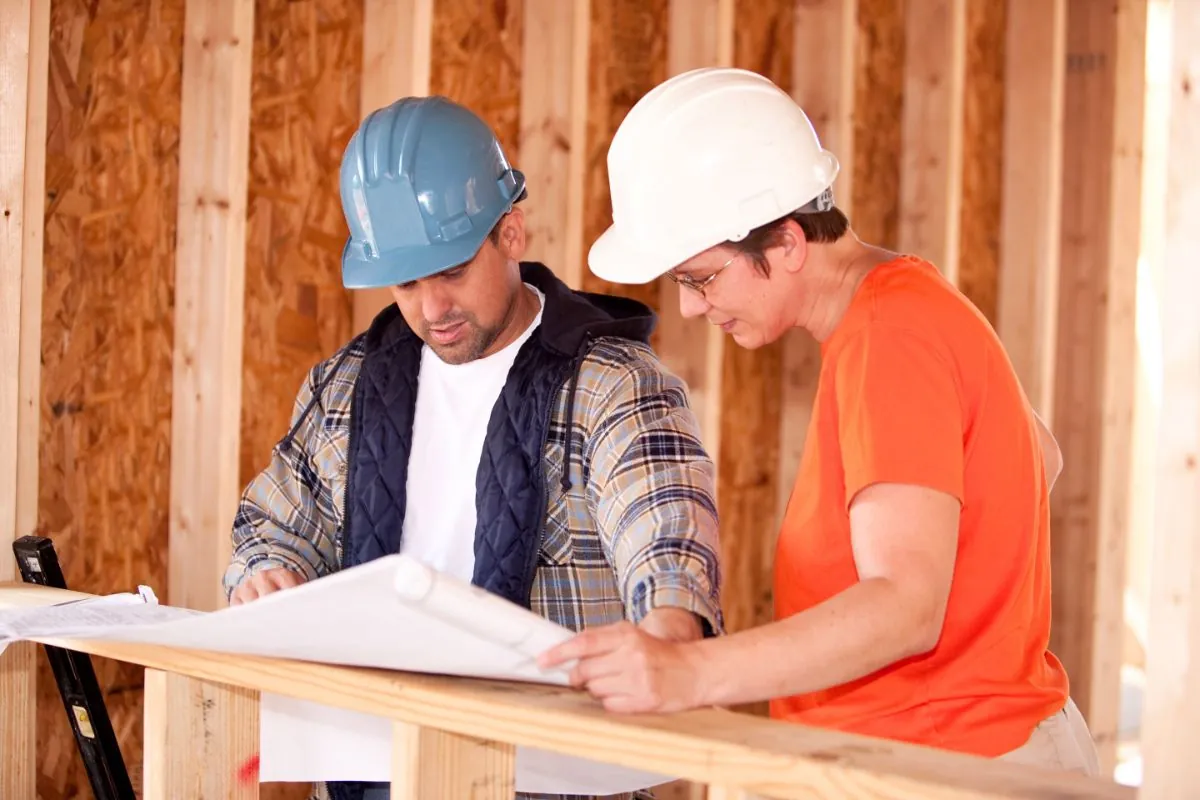 contractors talking to home owner for basement remodeling plan