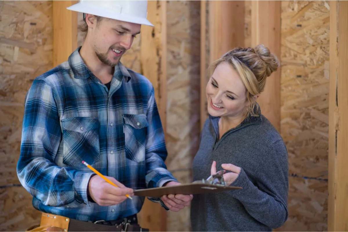 female homeowner going over basement renovation plan with contractor