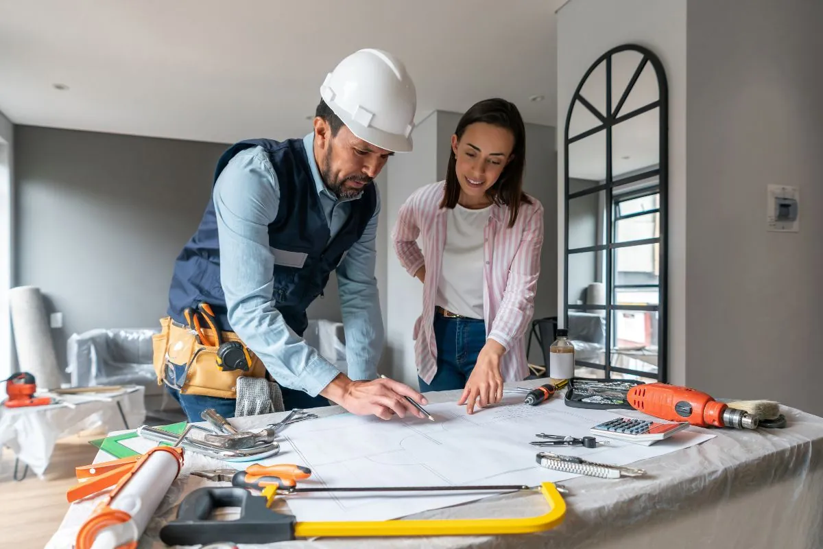 women renovating her basement talking to the contractor