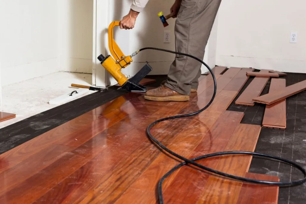 a man installing hardwood floors